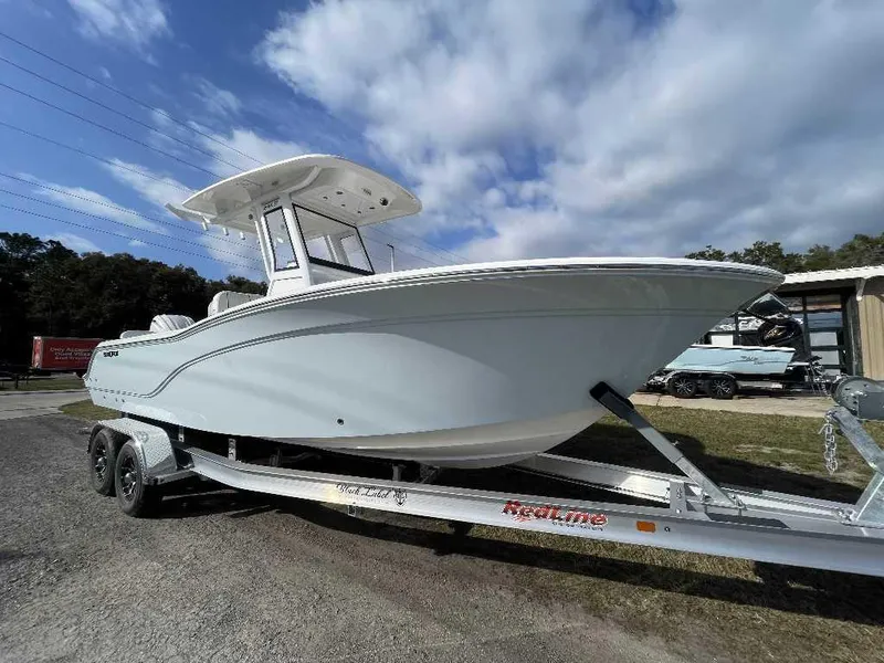 Slide: The Image of 2025 Sea Fox 248 Commander boat on trailer under a partly cloudy sky. - 0