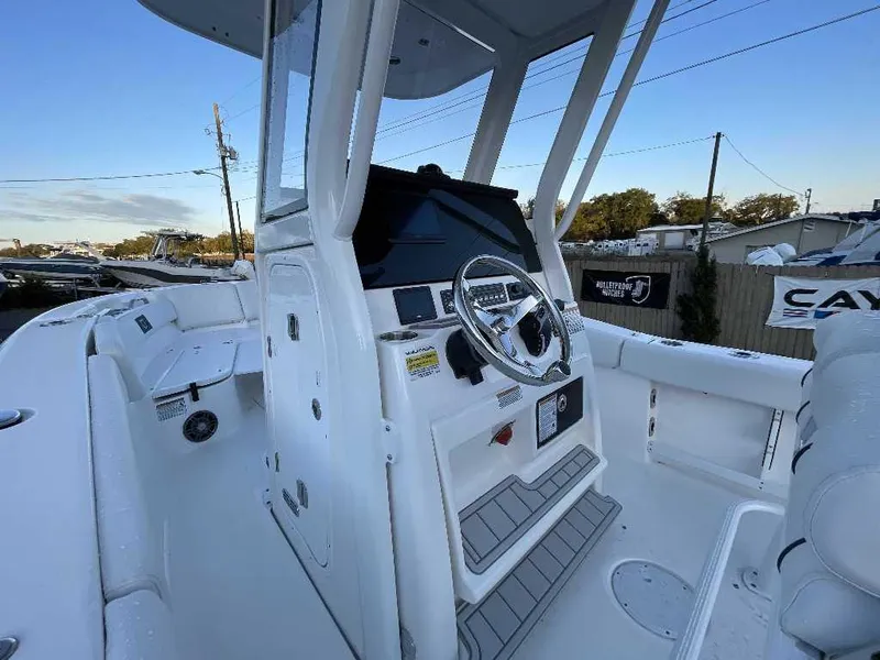 Slide: The Image of 2025 Sea Fox 248 Commander boat interior with steering wheel and seating area. - 1