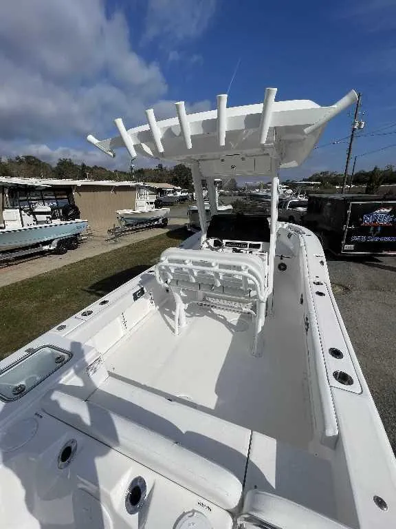 Slide: The Image of 2025 Sea Fox 248 Commander boat with spacious deck and T-top under a clear sky. - 10
