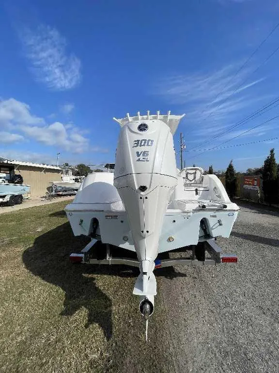 Slide: The Image of 2025 Sea Fox 248 Commander boat with powerful 300 V6 engine, parked outdoors. - 13