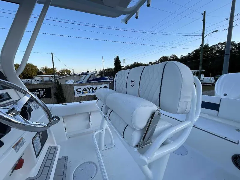 Slide: The Image of 2025 Sea Fox 248 Commander boat interior with white seating and steering wheel. - 2