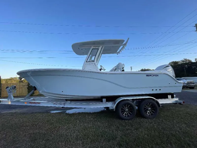 Slide: The Image of 2025 Sea Fox 248 Commander boat on trailer, side view under clear blue sky. - 5