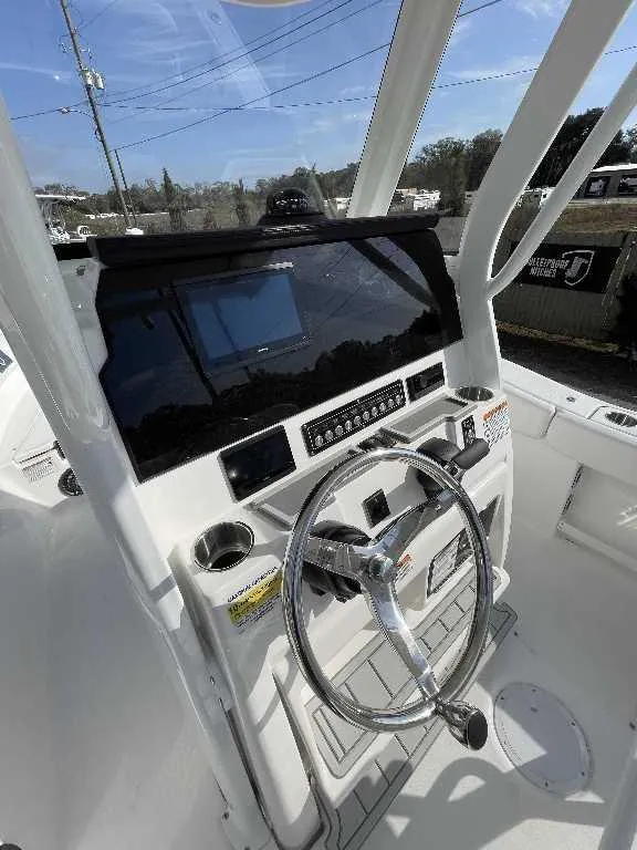 Slide: The Image of 2025 Sea Fox 248 Commander helm with steering wheel and control panel. - 8