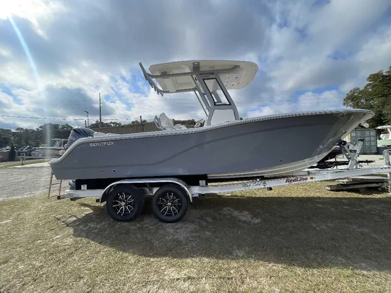 Slide: The Image of 2025 Sea Fox 248 Commander boat on trailer under cloudy sky. - 0