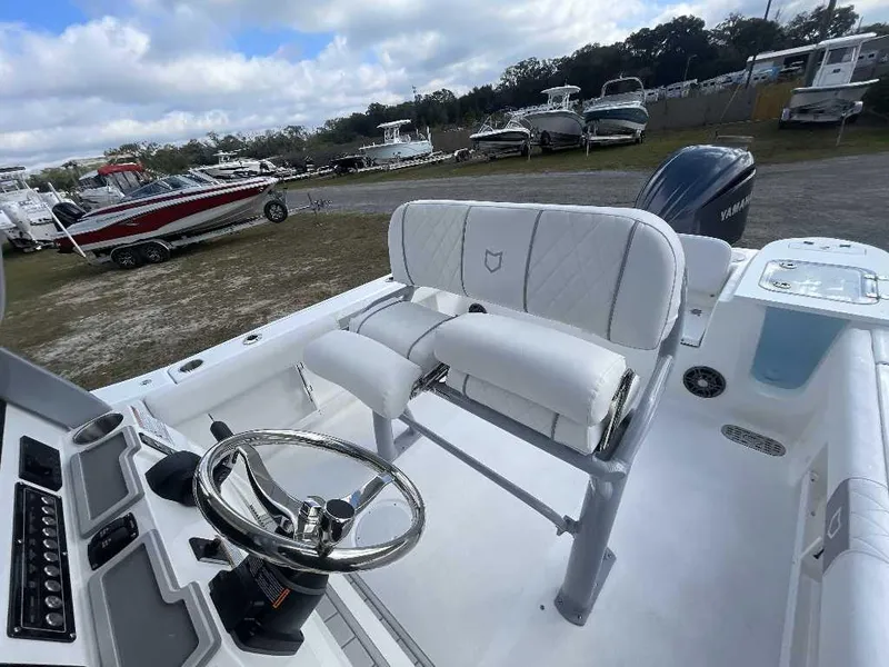 Slide: The Image of 2025 Sea Fox 248 Commander boat interior with steering wheel and seating. - 2
