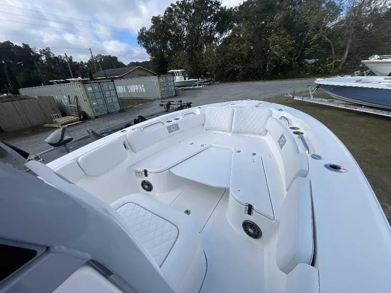 Slide: The Image of 2025 Sea Fox 248 Commander boat interior with white seating and spacious deck. - 5