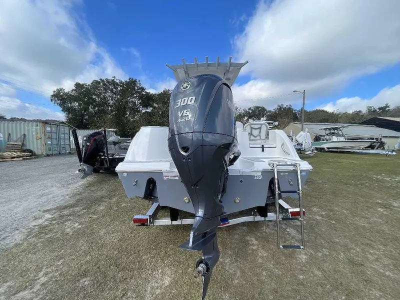 Slide: The Image of 2025 Sea Fox 248 Commander boat with powerful outboard motor, parked on grass. - 7