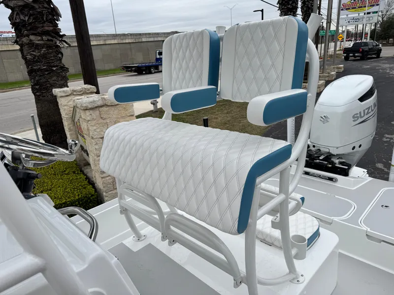 Slide: The Image of 2025 Shallow Sport 24 Modified V boat with white and blue cushioned seating. - 10