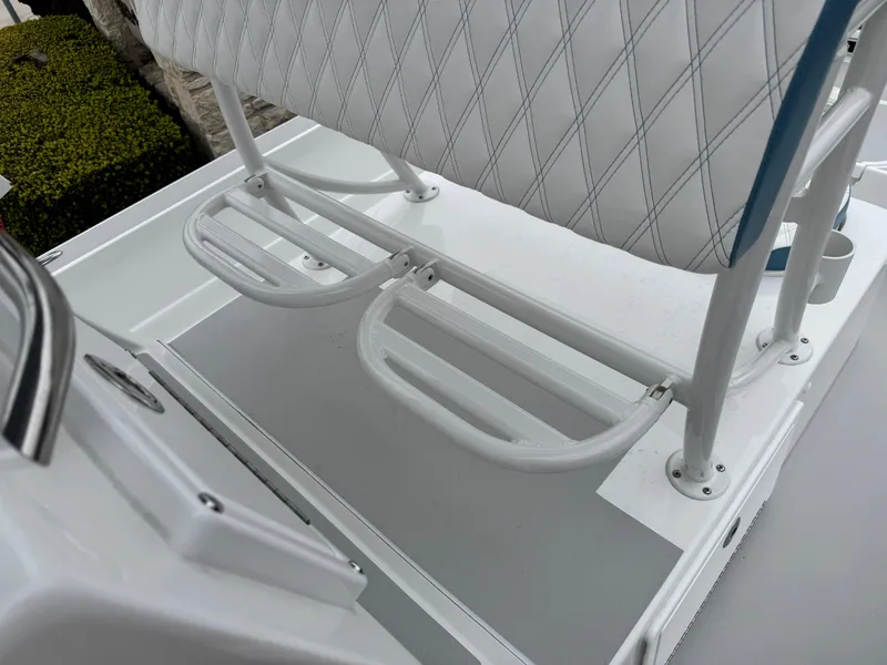 Slide: The Image of 2025 Shallow Sport 24 Modified V boat seating with white cushion and metal footrest. - 11