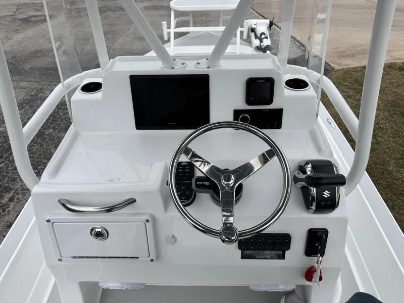 Slide: The Image of 2025 Shallow Sport 24 Modified V boat console with steering wheel and controls. - 13