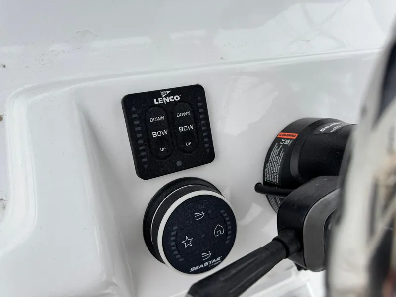 Slide: The Image of Control panel of 2025 Shallow Sport 24 Modified V boat, featuring Lenco and SeaStar systems. - 16