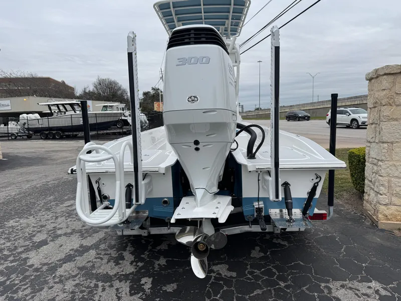 Slide: The Image of 2025 Shallow Sport 24 Modified V boat, rear view with powerful outboard motor. - 2