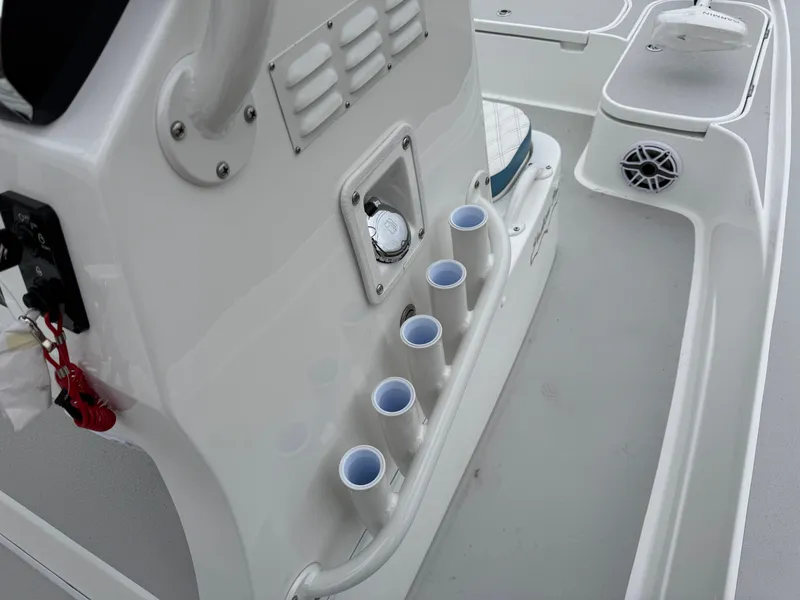 Slide: The Image of 2025 Shallow Sport 24 Modified V boat interior with rod holders and storage compartments. - 21