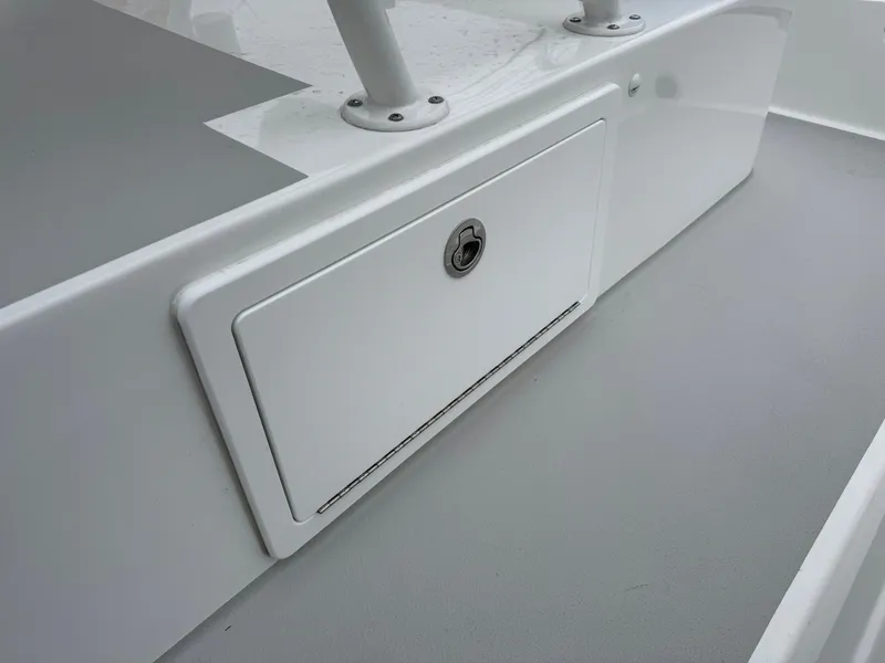 Slide: The Image of 2025 Shallow Sport 24 Modified V boat storage compartment, featuring a sleek, white design. - 25