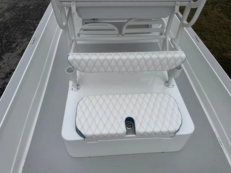 Slide: The Image of 2025 Shallow Sport 24 Modified V boat interior with white cushioned seating and storage. - 29