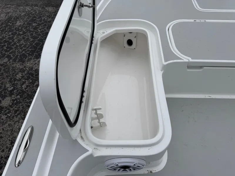 Slide: The Image of Open storage compartment on 2025 Shallow Sport 24 Modified V boat. - 32