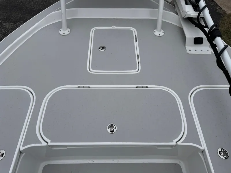 Slide: The Image of 2025 Shallow Sport 24 Modified V boat deck with storage compartments and clean design. - 33