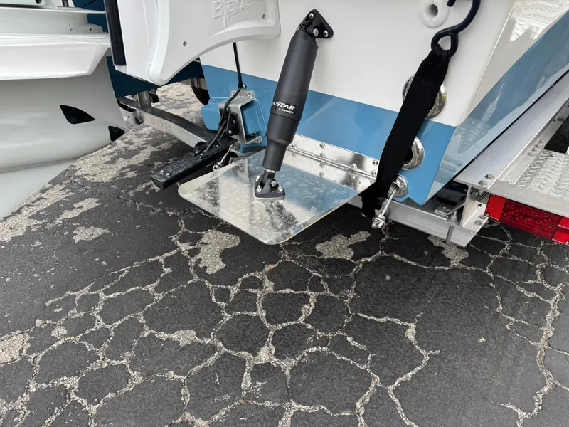 Slide: The Image of 2025 Shallow Sport 24 Modified V boat transom with trim tab and hydraulic actuator. - 4