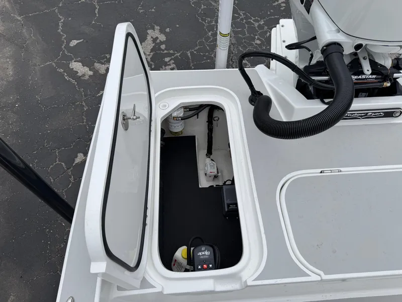 Slide: The Image of 2025 Shallow Sport 24 Modified V boat compartment with open hatch, showcasing interior components. - 42