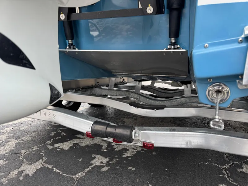 Slide: The Image of 2025 Shallow Sport 24 Modified V boat on trailer, showing hull and suspension details. - 6