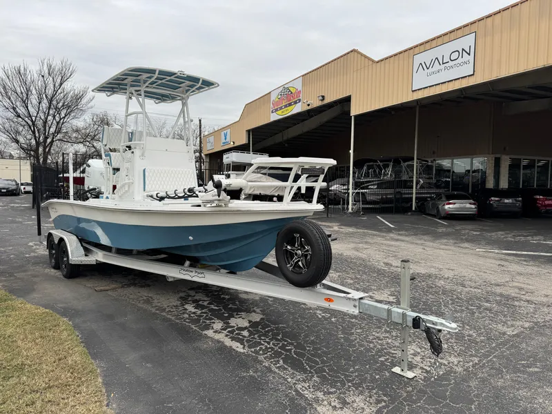 Slide: The Image of 2025 Shallow Sport 24 Modified V boat on trailer outside dealership. - 7