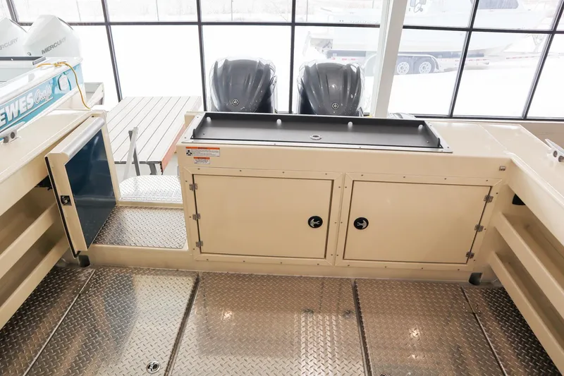 Slide: The Image of 2025 Hewescraft 290 Adventure ET HT boat interior with storage and dual engines. - 12
