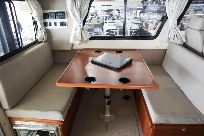 Slide: The Image of Interior of 2025 Hewescraft 290 Adventure ET HT, featuring a cozy dining area with a table. - 17