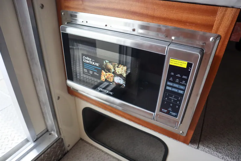 Slide: The Image of Built-in microwave in 2025 Hewescraft 290 Adventure ET HT boat interior. - 20