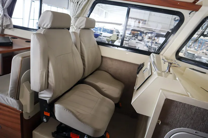 Slide: The Image of Interior of 2025 Hewescraft 290 Adventure ET HT boat with beige seating. - 25