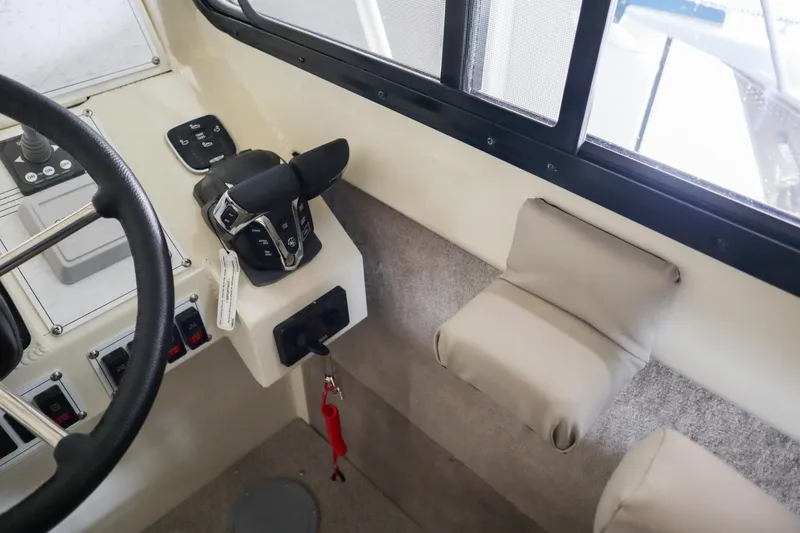 Slide: The Image of Interior view of 2025 Hewescraft 290 Adventure ET HT boat cockpit controls. - 29