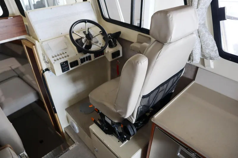 Slide: The Image of 2025 Hewescraft 290 Adventure ET HT boat interior with captain's chair and steering wheel. - 32