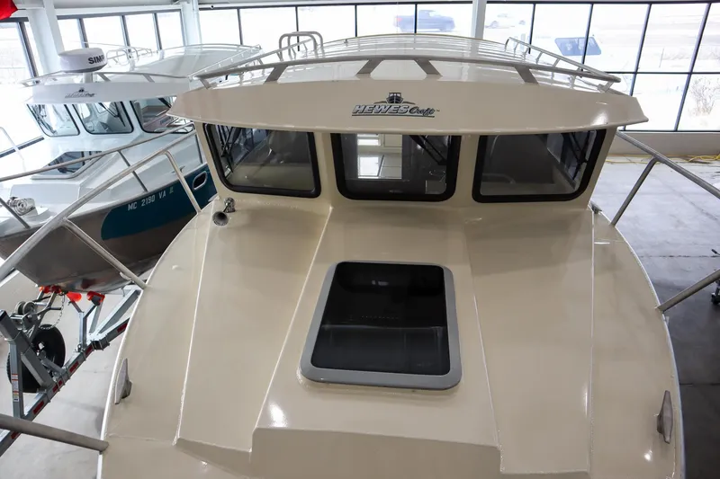 Slide: The Image of 2025 Hewescraft 290 Adventure ET HT boat in showroom, front view. - 42