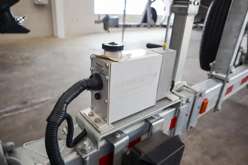 Slide: The Image of Close-up of a 2025 Hewescraft 290 Adventure ET HT trailer component in a garage. - 49