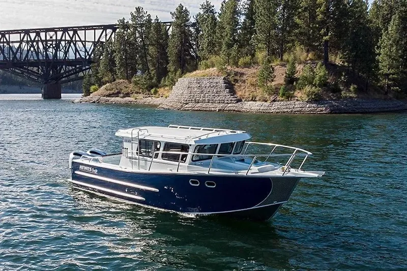 Slide: The Image of 2025 Hewescraft 290 Adventure ET HT boat on a scenic lake near a bridge. - 52