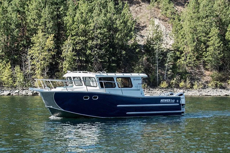 Slide: The Image of 2025 Hewescraft 290 Adventure ET HT boat cruising on a scenic lake. - 53