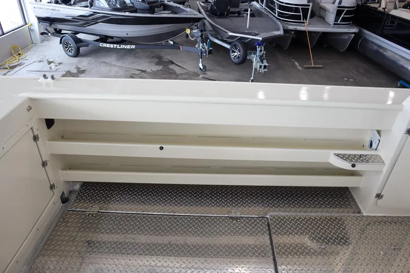 Slide: The Image of 2025 Hewescraft 290 Adventure ET HT boat interior with storage compartments and diamond plate flooring. - 8