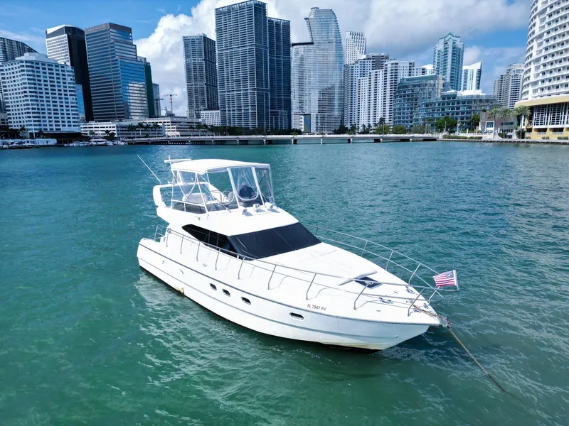 The Image of Azimut 43 yacht from 1997 on water with city skyline in background. - 0
