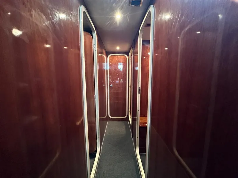 Slide: The Image of Interior hallway of a 1997 Azimut 43 yacht with wooden paneling. - 17