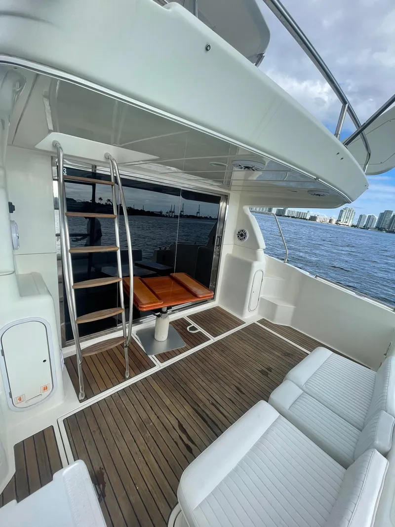 Slide: The Image of 1997 Azimut 43 yacht deck with seating, ladder, and ocean view. - 21