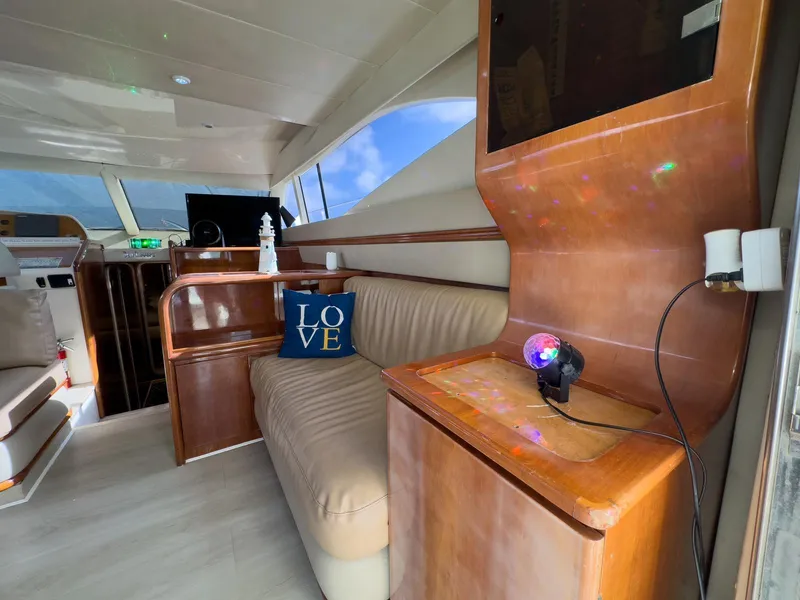 Slide: The Image of Interior of 1997 Azimut 43 yacht with beige seating and decorative pillow. - 25
