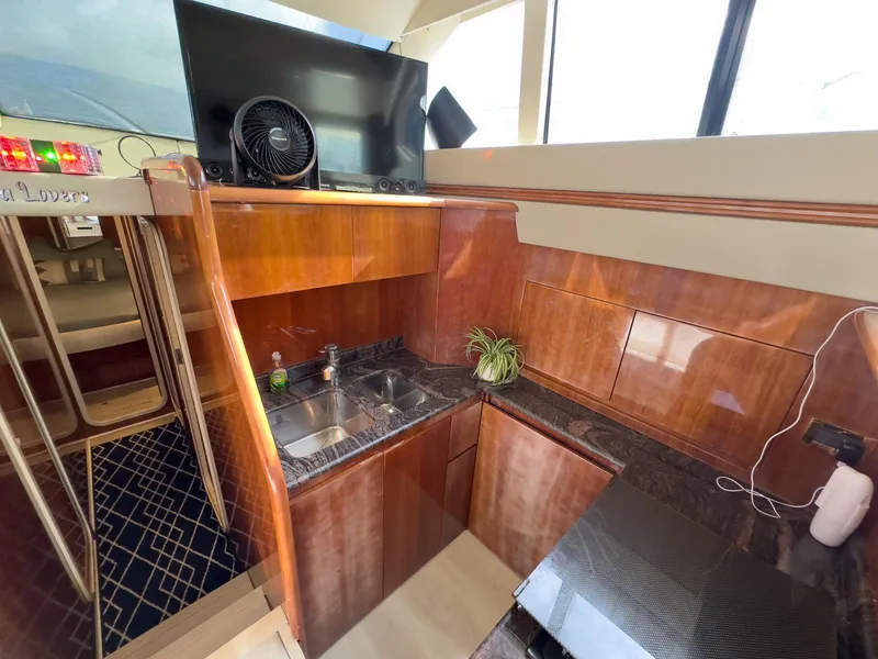 Slide: The Image of Interior of 1997 Azimut 43 yacht kitchen with wood finish and modern amenities. - 27