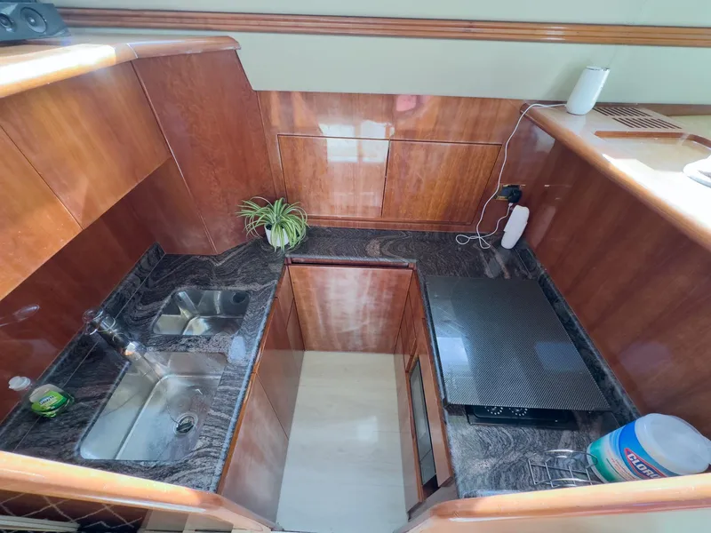 Slide: The Image of Luxurious kitchen interior of a 1997 Azimut 43 yacht with wood and marble finishes. - 28