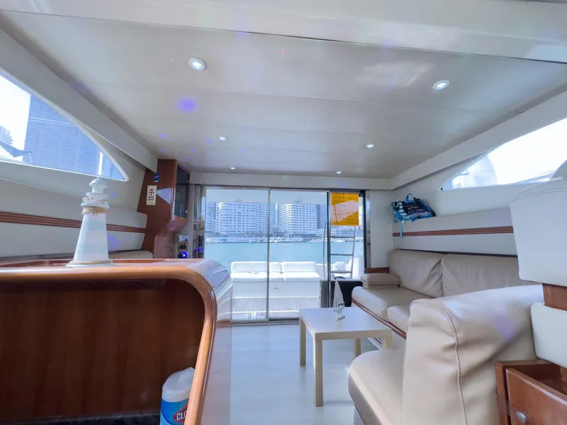 Slide: The Image of Interior of a 1997 Azimut 43 yacht, featuring modern seating and large windows. - 29