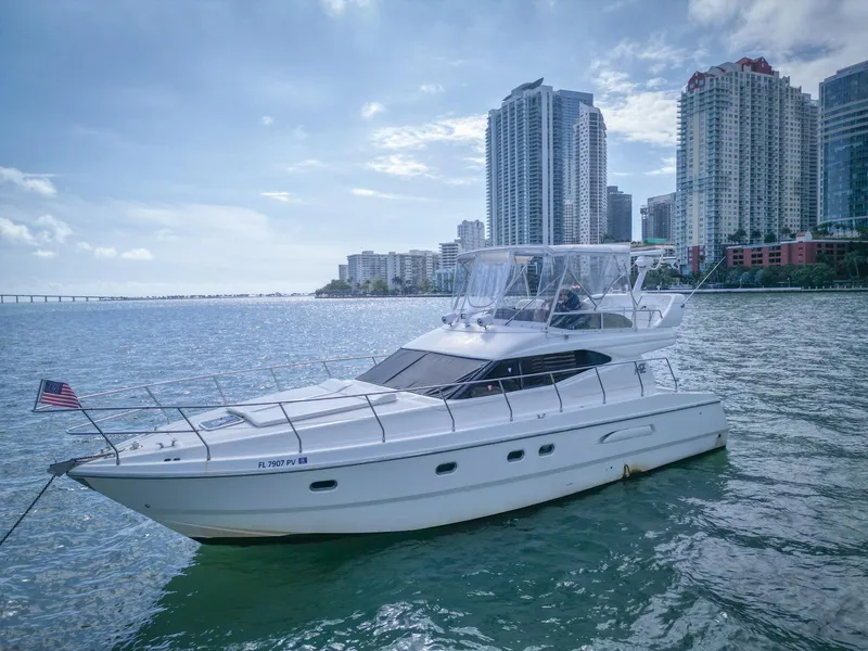 Slide: The Image of Azimut 43 yacht from 1997 on water, city skyline in background. - 3