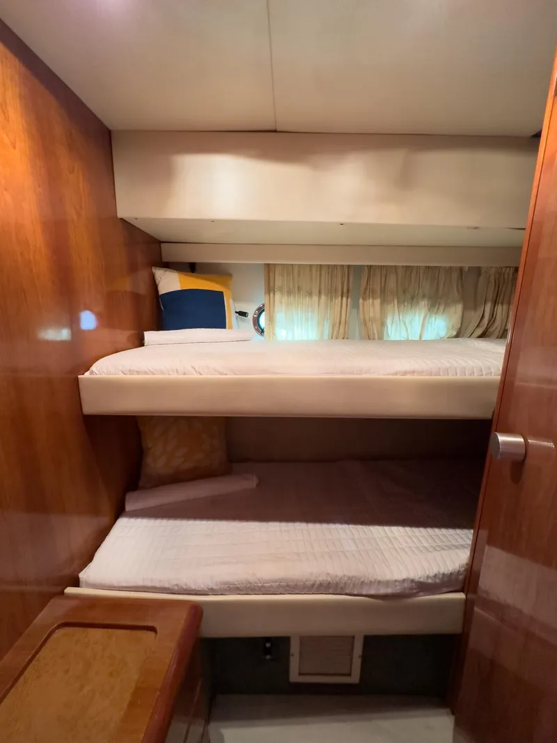 Slide: The Image of Interior of 1997 Azimut 43 yacht with wooden bunk beds and cozy decor. - 32