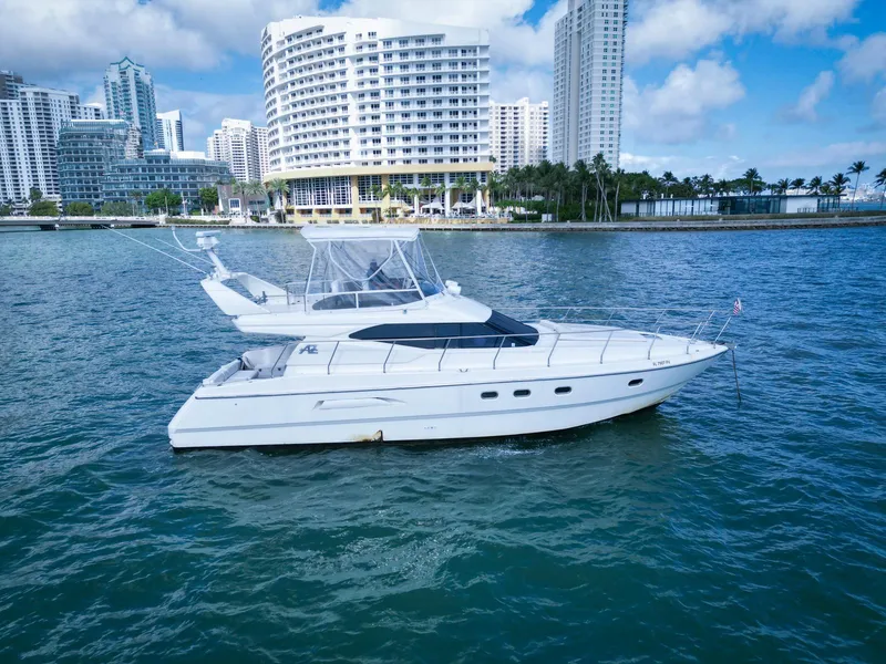Slide: The Image of Azimut 43 yacht from 1997 on water with city skyline background. - 4