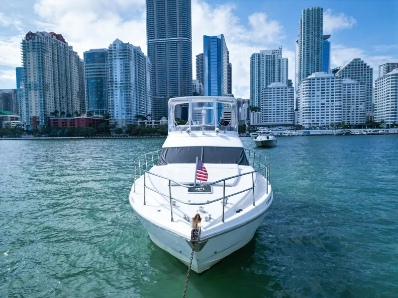 Slide: The Image of Azimut 43 yacht from 1997 on water with city skyline in background. - 5