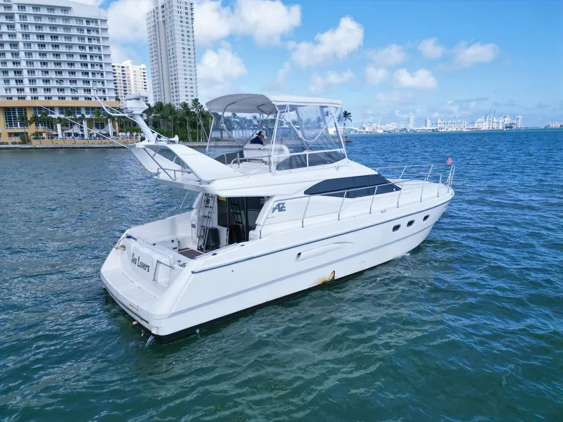 Slide: The Image of Azimut 43 yacht from 1997 cruising near city skyline on a sunny day. - 6