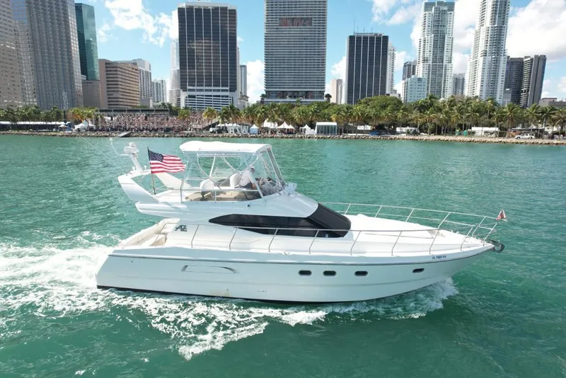 Slide: The Image of Azimut 43 yacht cruising in city waters, 1997 model, with skyscrapers in the background. - 9