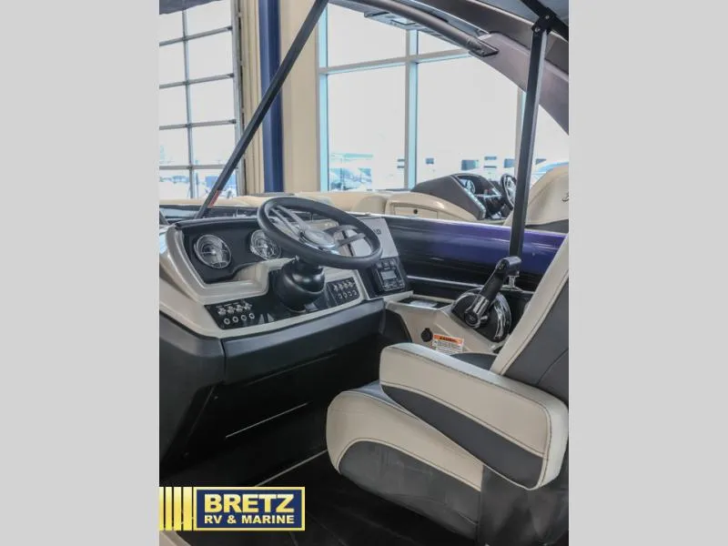 Slide: The Image of 2023 Cabrio 24UC boat interior with steering wheel and captain's chair at Bretz RV & Marine. - 11